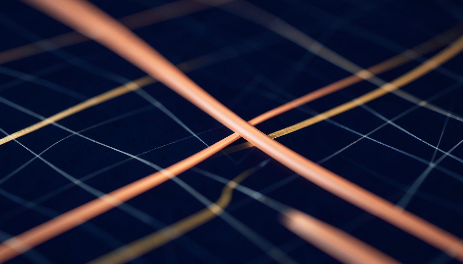 Softly glowing terracotta and gold lines crossing a dark navy grid, evoking data pathways in a calm network environment.